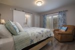 Master Bedroom features a queen bed, access to the backyard and en suite bath